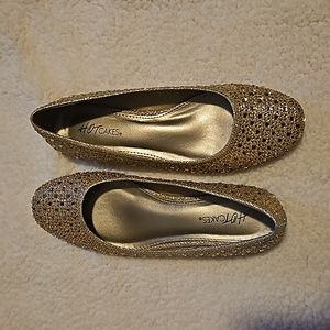 Gold sparkly flats.